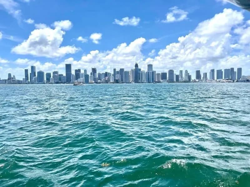 Boat cruising Miami Bay at golden hour
