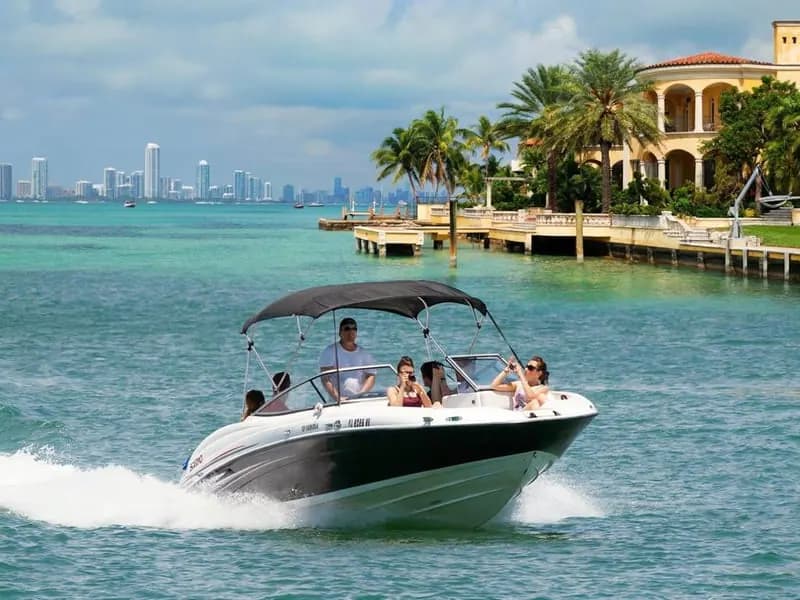 Private boat passing a Miami waterfront mansion